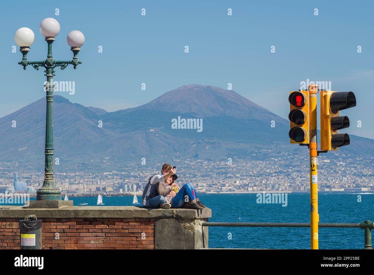 Adolescents heureux couple, vue en été d'un jeune couple prenant une photo de selfie d'eux-mêmes contre la baie de Naples et le Vésuve, Italie Banque D'Images