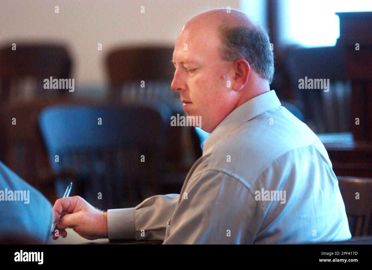 John W. Dilley Jr. avoids eye contact with his estranged wife Jennifer