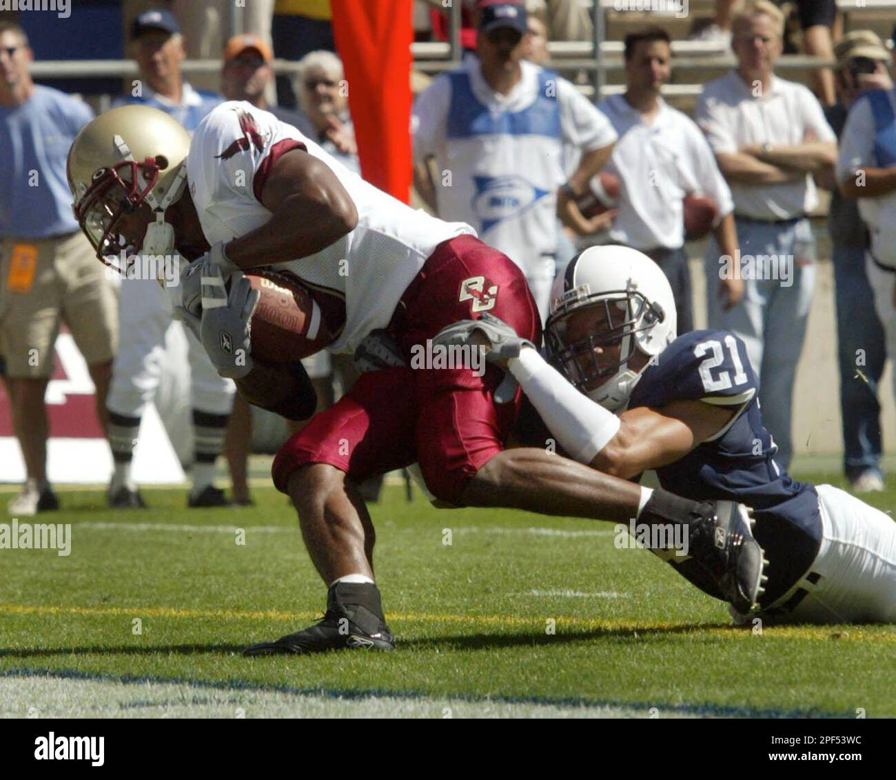 Boston College's Grant Adams, left, scores the first touchdown of the game as Penn State's Alan Zemaitis (21), holds on during the first quarter at Beaver Stadium in State College Pa., Saturday Sept. 6, 2003.(AP Photo/Chris Knight) Banque D'Images