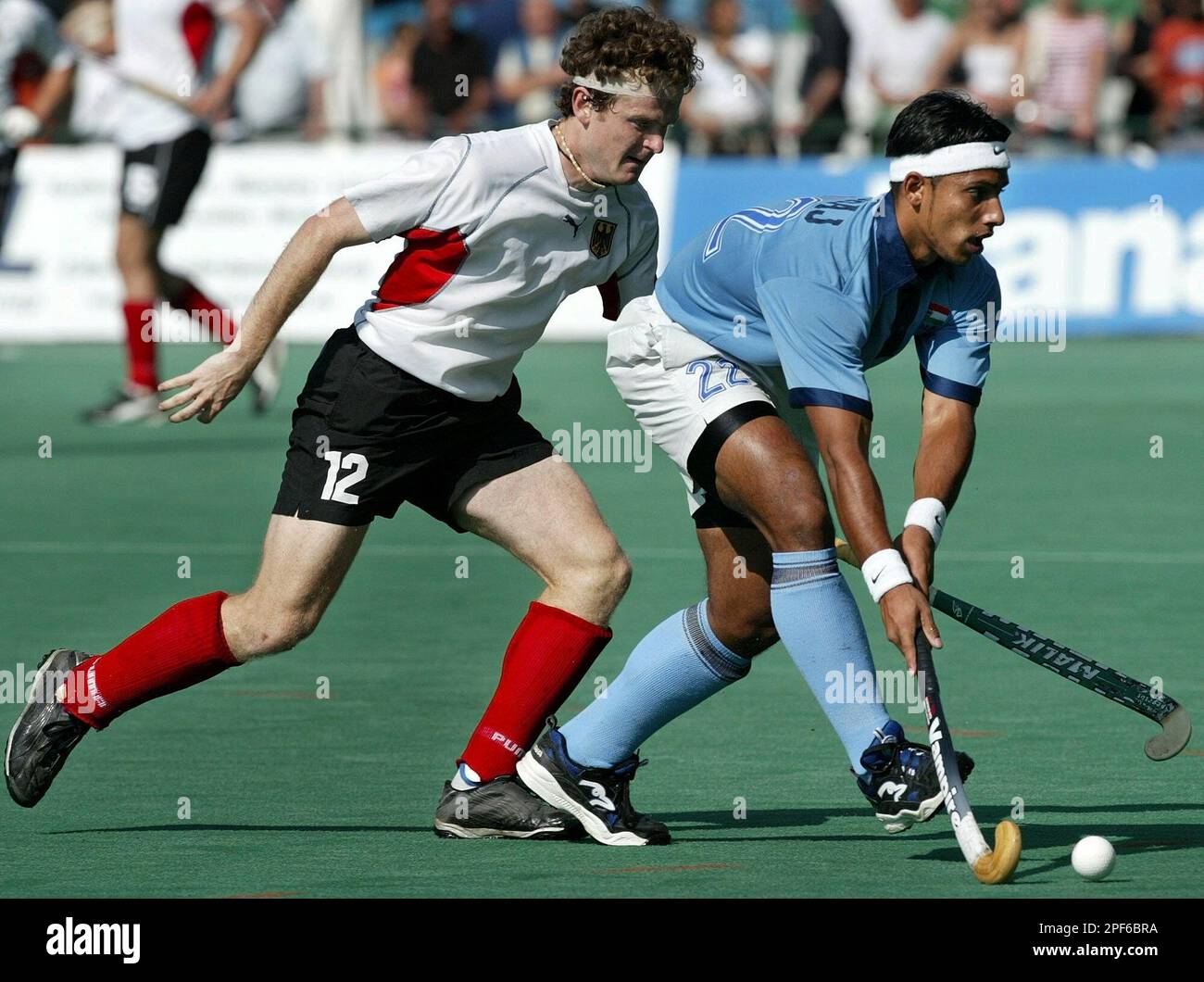 German hockey player Sebastian Biederlack, left, and Indian hockey player  Jugraj Singh, right, challenge for the ball during the hockey match between  India and Germany at the Hamburg's Masters Hockey tournament in