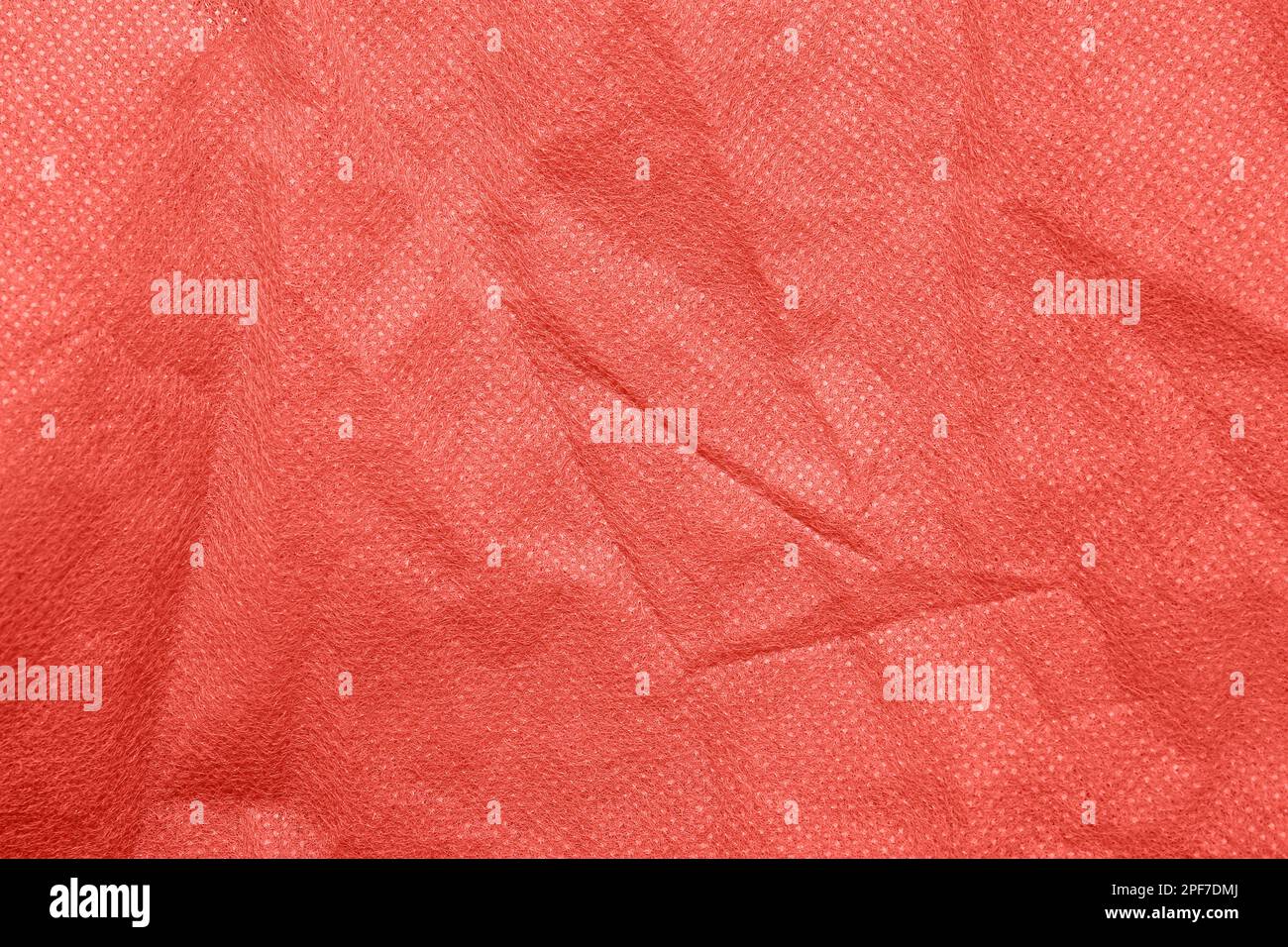 Gros plan sur la texture du tissu en polyester corail comme arrière-plan Banque D'Images