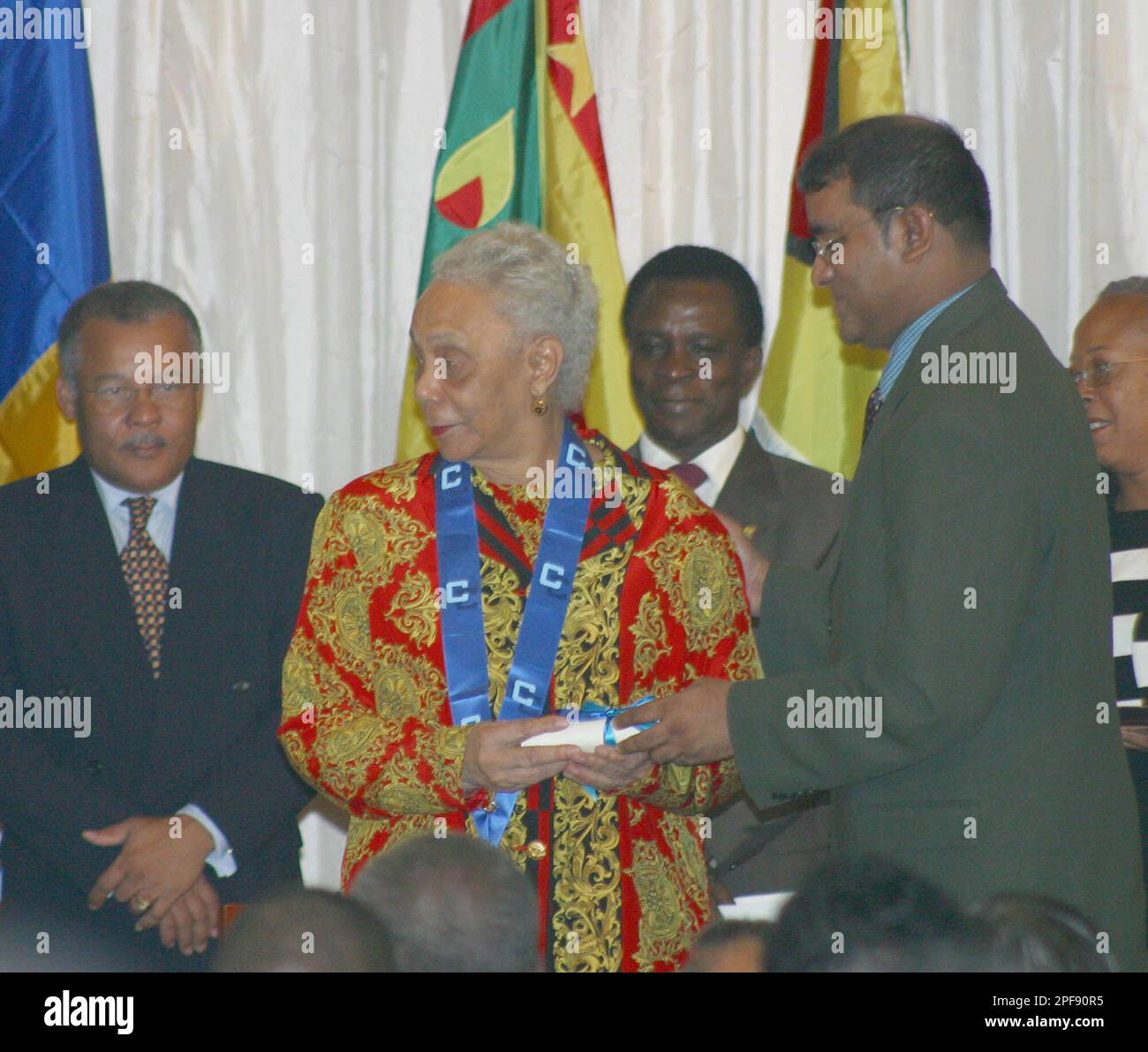 Dame Mary Eugenia Charles, former prime minister of the Commonwealth of Dominica, receives the Order of the Caribbean Community (OCC) from President of Guyana Bharrat Jagdeo during the opening ceremony inter-sessional meeting of the Confrence of the Heads of Government of the Caribbean Friday, Feb. 14, 2003 in Port Of Sapin, Trinidad. (AP Photo/Shirley Bahadur) Banque D'Images