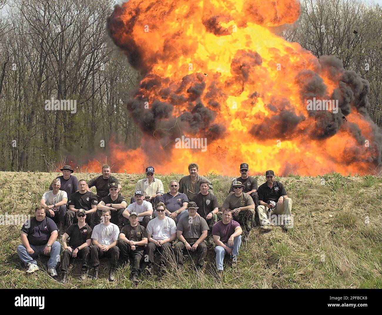 Law enforcement personnel pose for a group photo as 10 gallons of