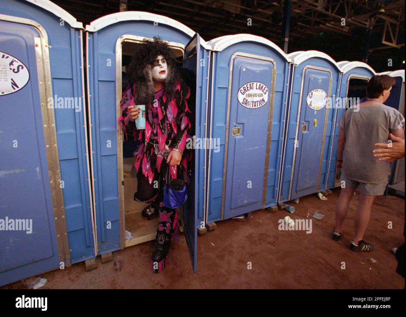 Darren Pavesi of Woodcliff Lake, N.J., leaves one of the portable toilets on the infield at Tiger Stadium before a concert by the band Kiss in Detroit on Friday, June 28, 1996. Pavesi, dressed as his favorite band member, Paul Stanley, traveled from New Jersey just for the Detroit show.(AP Photo/Tom Pidgeon) Banque D'Images