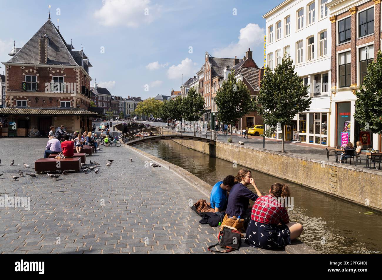 Les gens sont assis le long du canal dans la ville de Leeuwarden en Frise. Banque D'Images