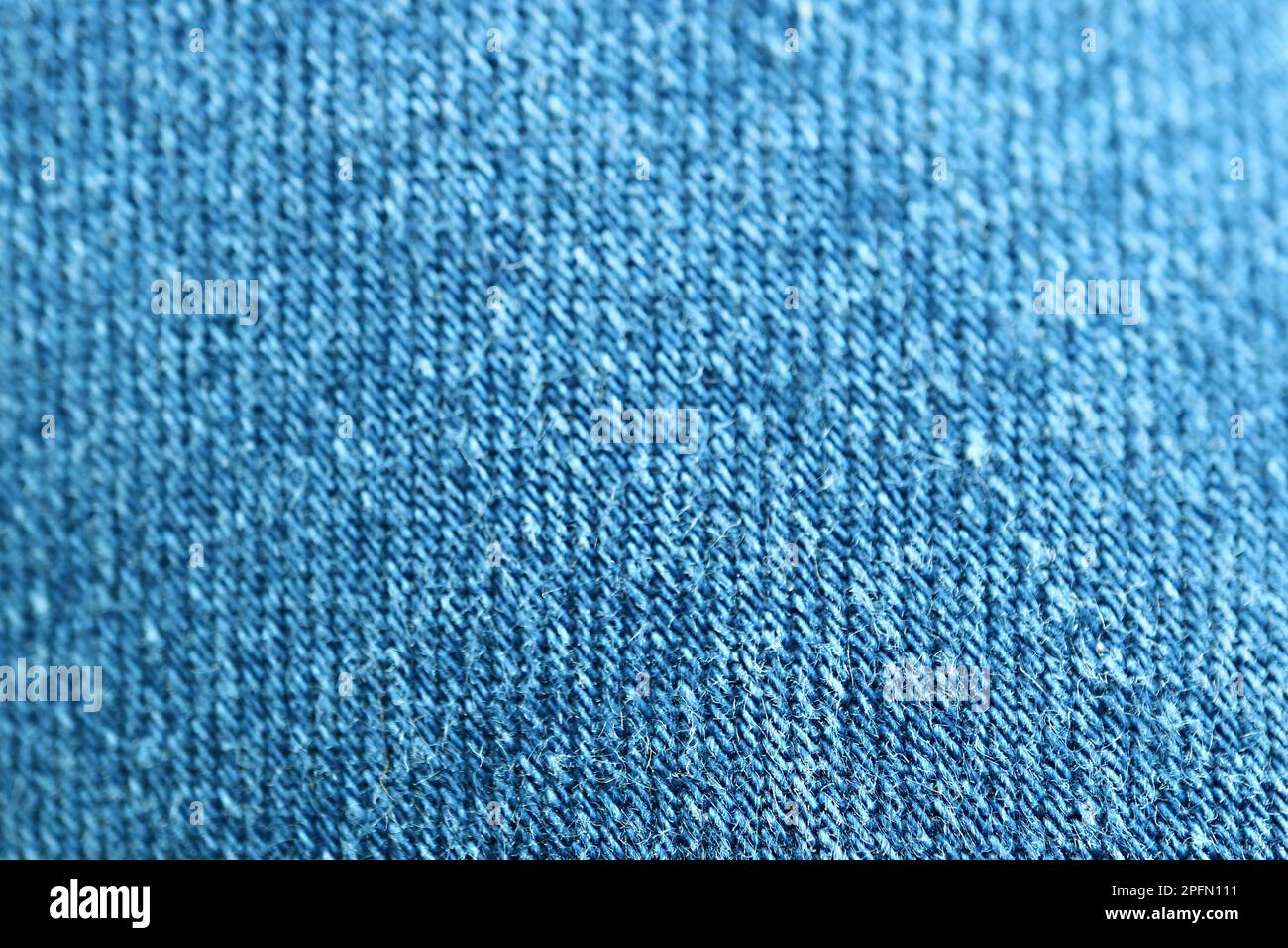 Gros plan sur la texture du tissu Blue Jeans avec mise au point sélective Banque D'Images