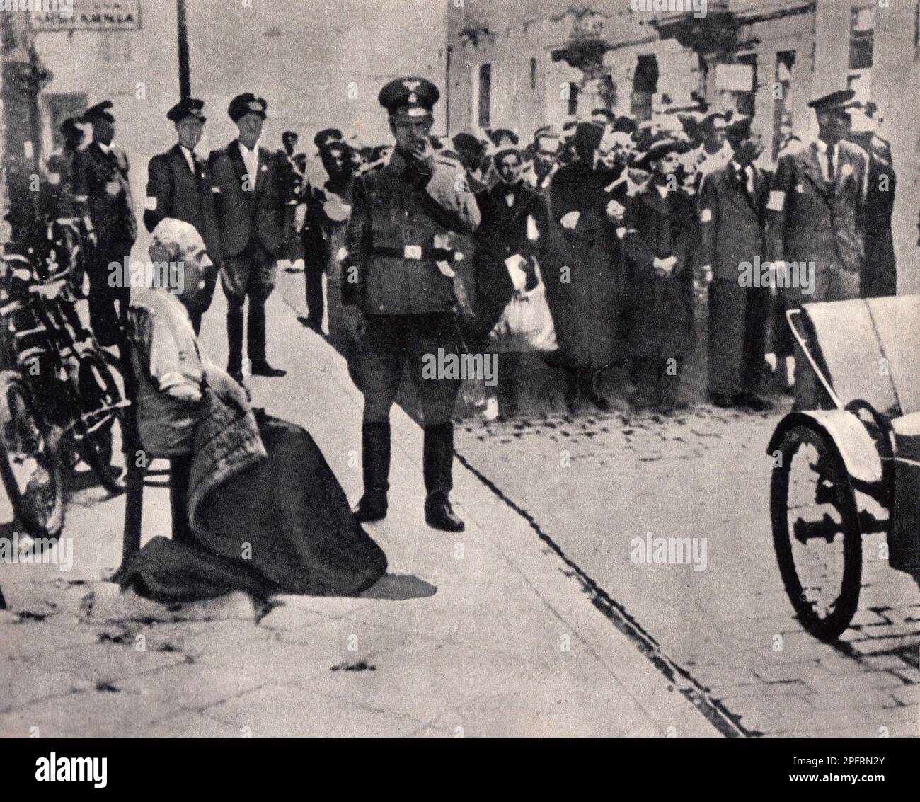 En janvier 1943, les nazis sont arrivés pour arrondir les Juifs du ghetto de Varsovie les Juifs, résolus au combattre, ont pris la SS avec des armes maison et primitives. Les défenseurs ont été exécutés ou déportés et la zone du ghetto a été systématiquement démolie. Cet événement est connu sous le nom de soulèvement du ghetto. Cette image montre un groupe de Juifs et un vieil homme assis sur une chaise attendant d'être déportés à leur mort Banque D'Images