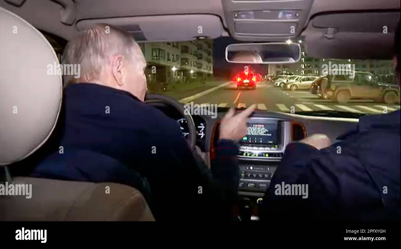 In this photo taken from video released by Russian Presidential Press Office on Sunday, March 19, 2023, Russian President Vladimir Putin, left, and Russian Deputy Prime Minister Marat Khusnullin, right, drive a car during their visit to Mariupol in Russian-controlled Donetsk region, Ukraine. Putin has traveled to Crimea to mark the ninth anniversary of the Black Sea peninsula's annexation from Ukraine. (Russian Presidential Press Office via AP) Banque D'Images