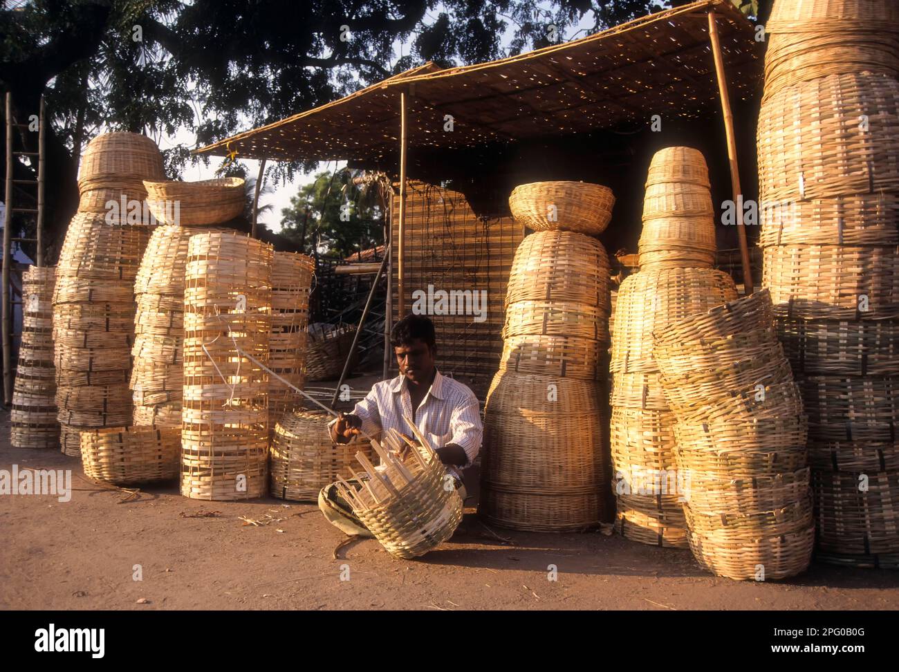 Un homme qui vannette des paniers en bambou à Lawley Road à Coimbatore, Tamil Nadu, Inde, Asie Banque D'Images