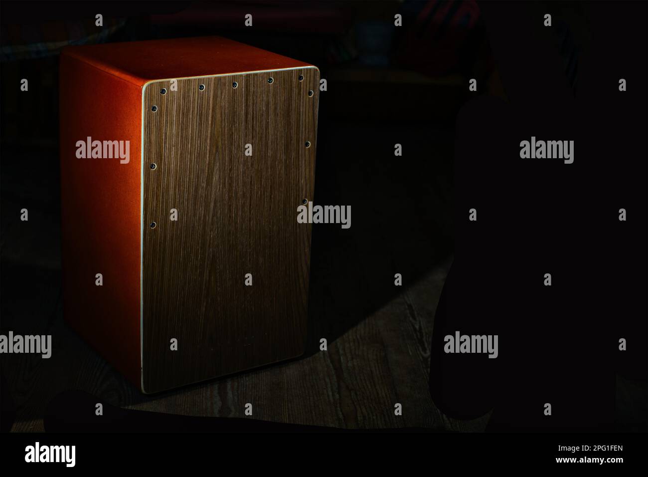 Un instrument de musique percussif de cajon sur fond noir Banque D'Images