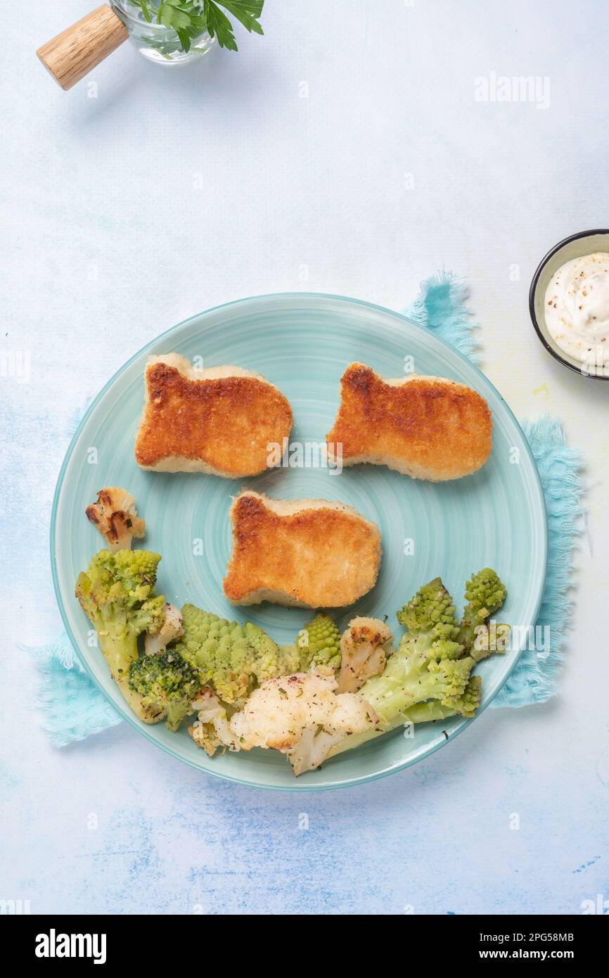 Nourriture pour enfants. Nuggets en forme de poisson avec légumes Banque D'Images