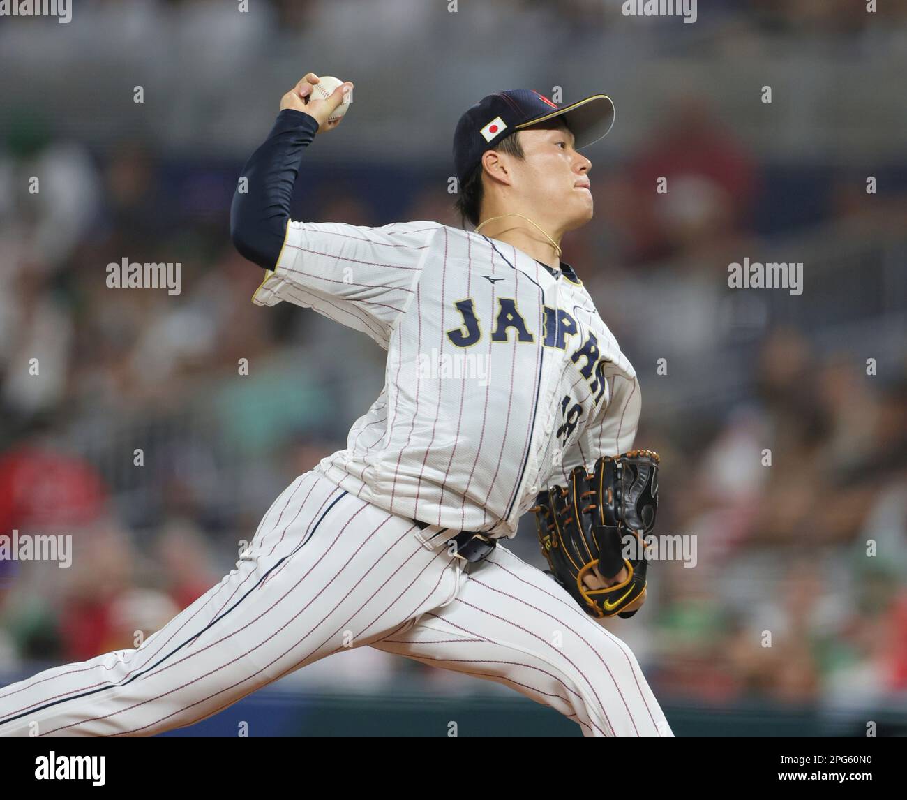 Yoshinobu Yamamoto of Japan throws a ball during the World Baseball