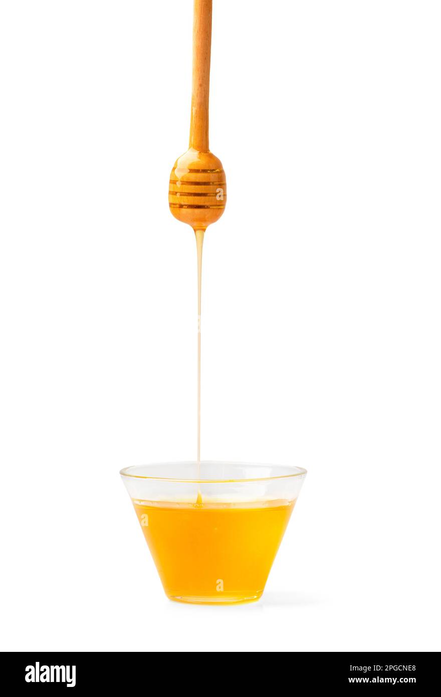 Miel dans un bol avec du miel provenant d'une cuillère sur fond blanc. Miel avec balancier de miel isolé. Banque D'Images