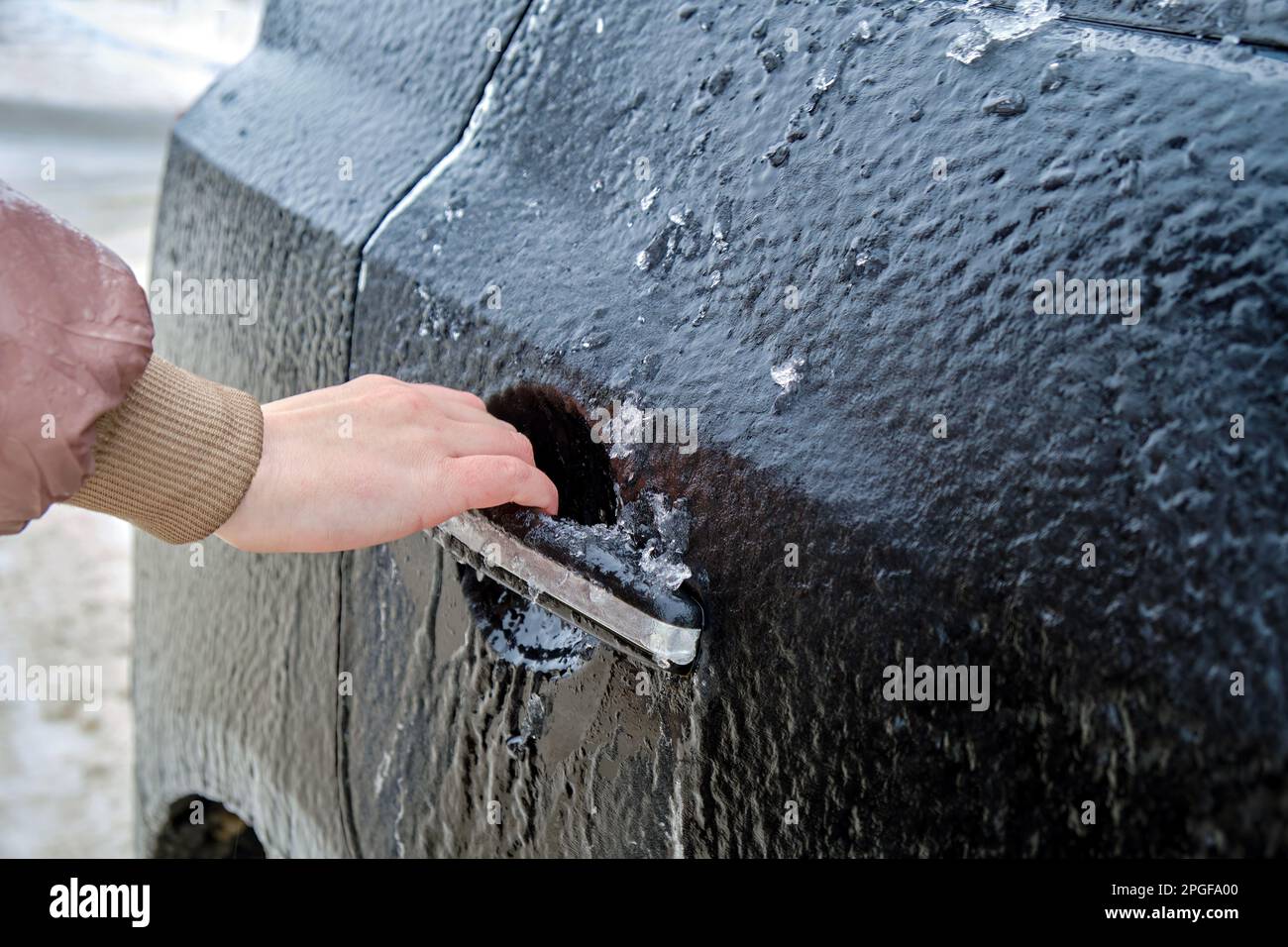 congélation des poignées de porte de voiture et tentative d'ouverture Banque D'Images