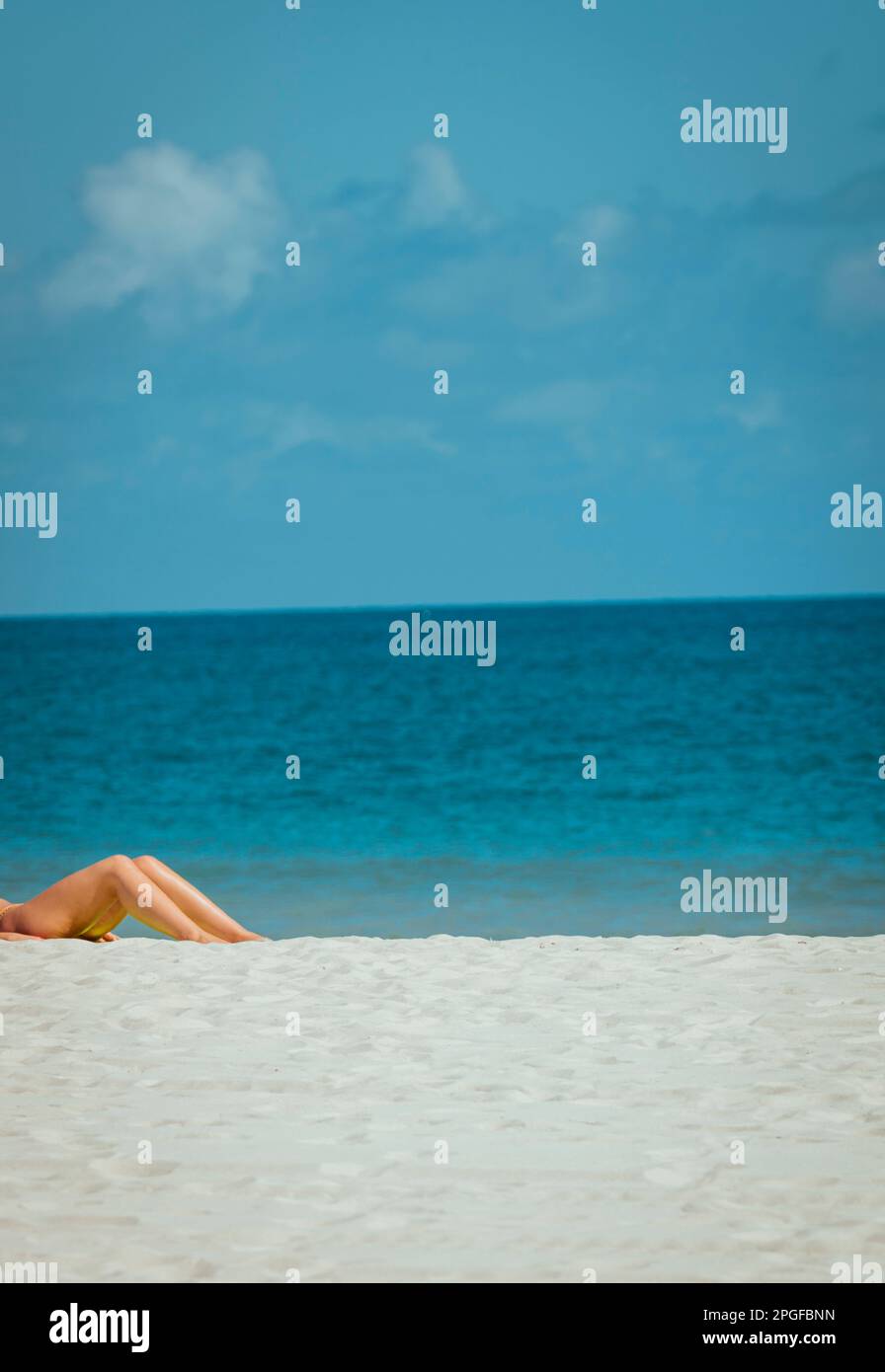 femme sur la plage jambes bleu de mer se détendre Banque D'Images