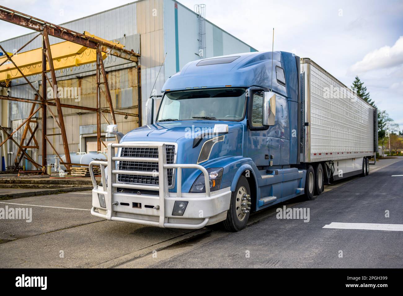 Semi-camion gris PRO avec grille de protection en aluminium et semi-remorque pour réfrigérateur avec porte arrière ouverte à proximité de l'entrepôt sur la surface de stockage Banque D'Images