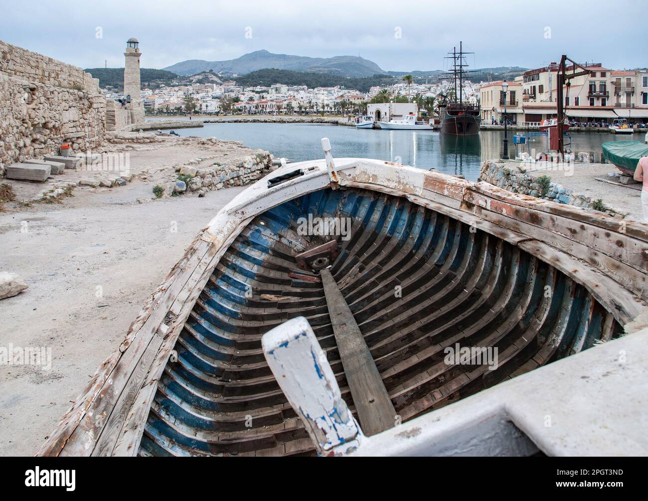 Zone portuaire de Réthymnon, Crète, Grèce avec le bateau traîné sur la cale avec phare et bateau pirate dans cette scène portuaire. Banque D'Images