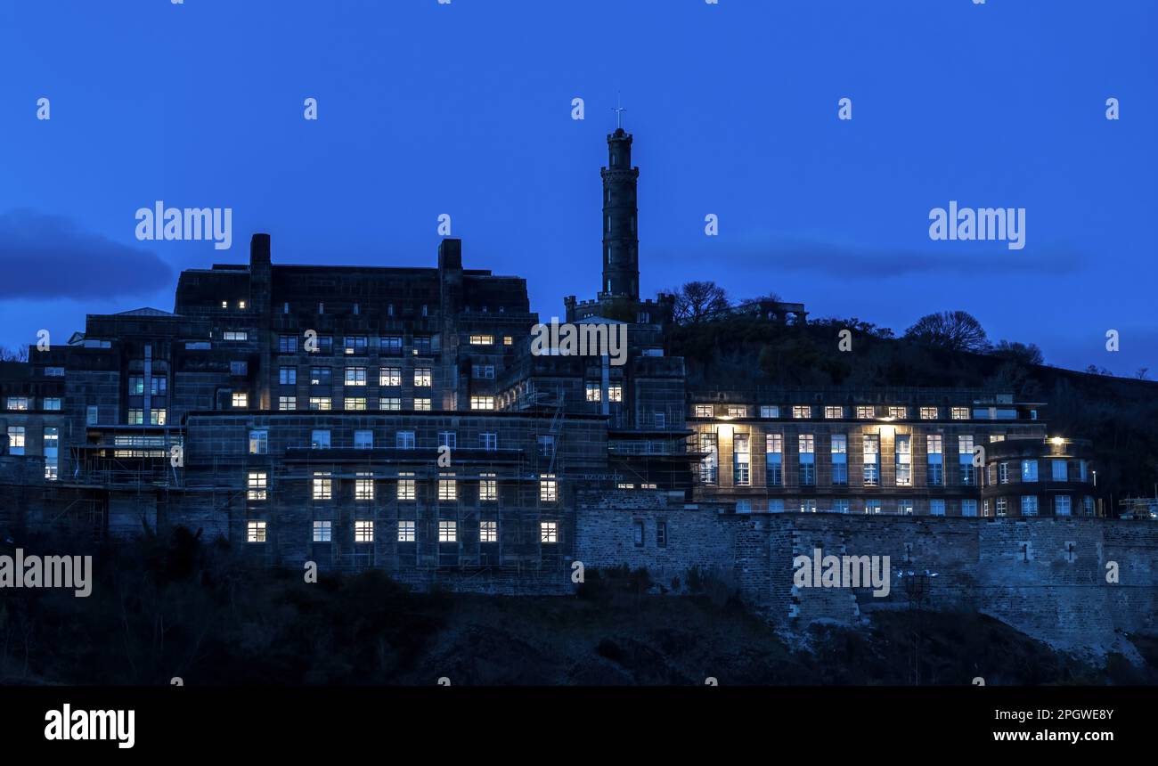 Le siège social du gouvernement écossais, le bâtiment de la maison St Andrew, s'est éclairé la nuit avec le monument Nelson sur Calton Hill, Édimbourg, Écosse, Royaume-Uni Banque D'Images