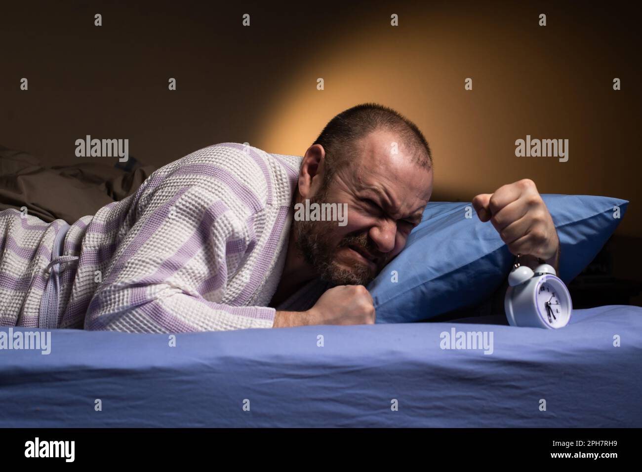 L'homme est réveillé de manière agressive par la sonnerie du réveil. Matin  faramineux. Réveil agaçant le matin. Je n'aime pas me réveiller dans la  plus haute des deux Photo Stock - Alamy