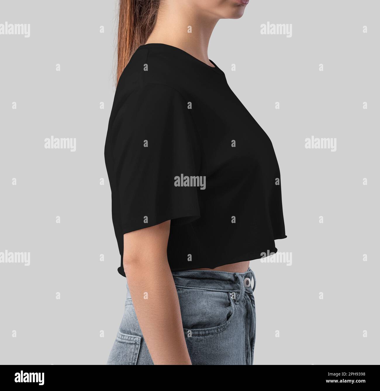 Maquette d'un petit top noir sur une fille avec posture, vue latérale, vêtements mode pour femmes, pour le design, la marque, publicité. Modèle de t-shirt bella en toile, Banque D'Images