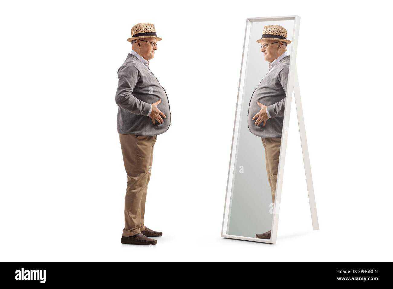 Photo de profil sur toute la longueur d'un homme âgé avec un grand ventre debout devant un miroir isolé sur fond blanc Banque D'Images