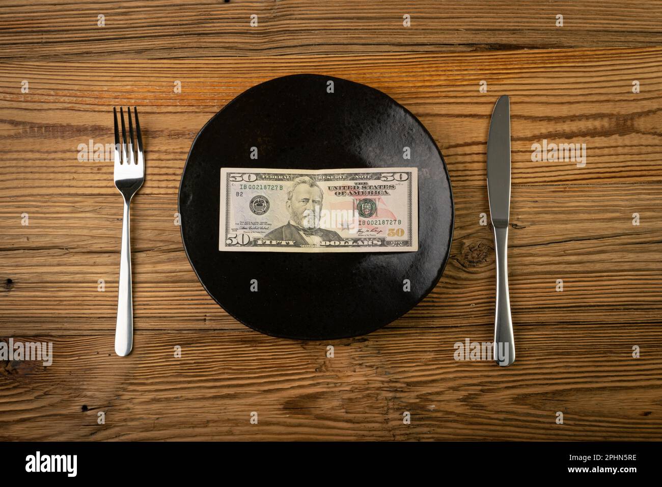 Argent sur plaque, concept des dépenses alimentaires, dollar papier comme nourriture, manger de l'argent, pension, bourse d'études, subvention, Salaire vivant, Banknote on a plate Top View Banque D'Images