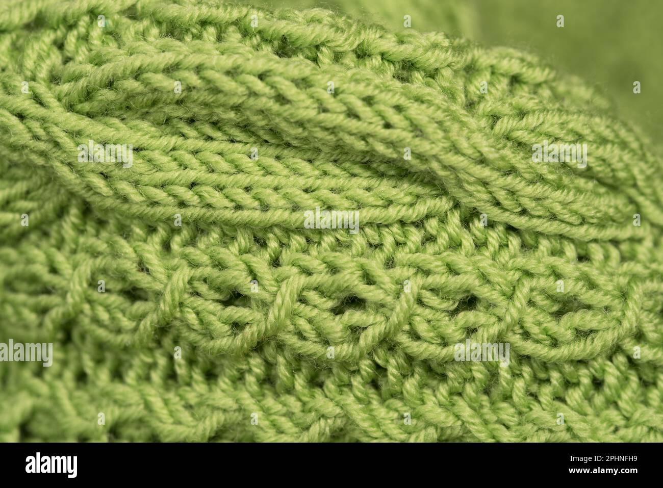 un bel maglione fatto a mano di colore verde, macro su un maglione fatto a mano, je regali utili, l'arte del saper fare a maglia Banque D'Images