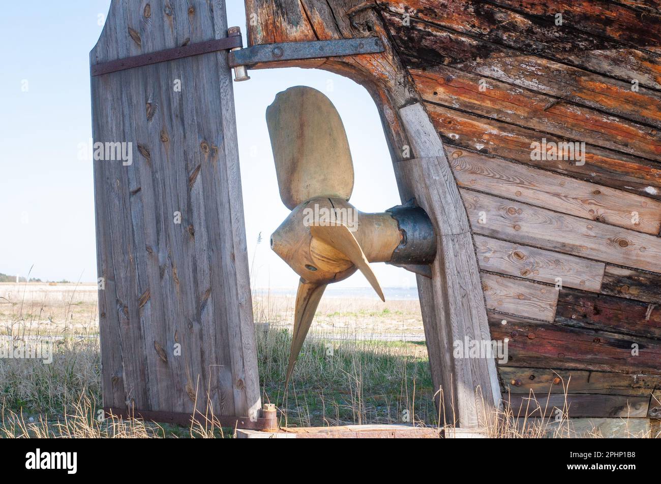 Un ancien naufrage en bois abandonné avec une hélice en cuivre. Planches en bois de l'ancien bateau à coque rétro. Banque D'Images