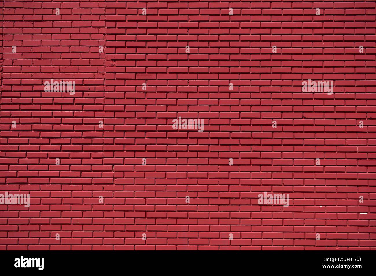 Nettoyer le fond rouge profond du mur de briques des fêtes Banque D'Images