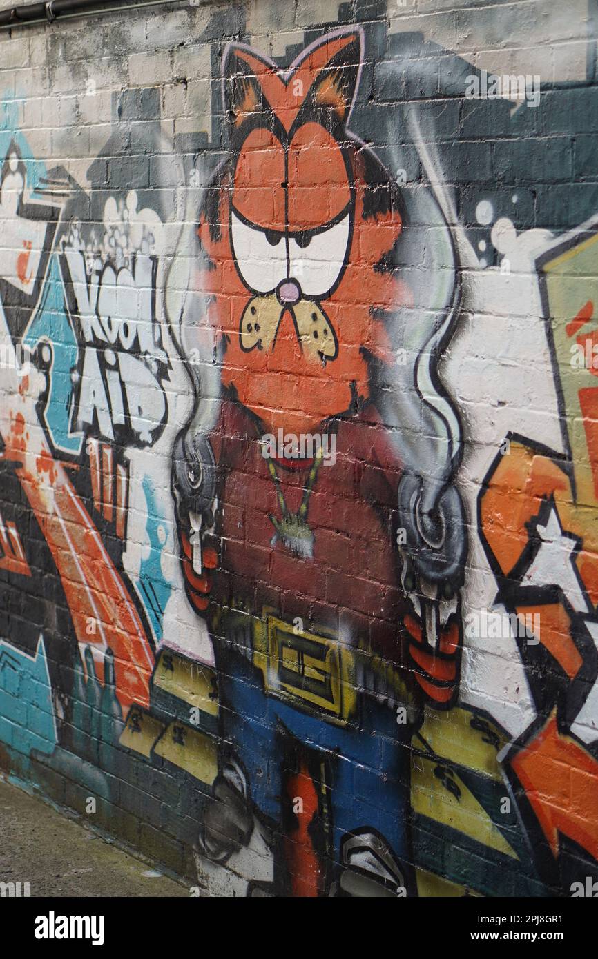 Street art trouvé à Sydney Australie. Garfield, John et Odie. Une fresque représentant la violence des armes à feu et un autre cri de paix. Banque D'Images