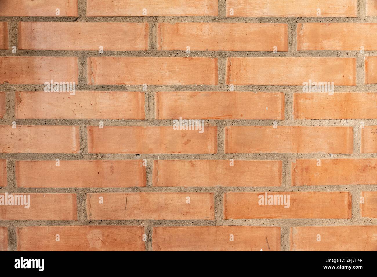 Mur en briques rouges, adapté comme fond d'écran ou motif de papier peint. Banque D'Images