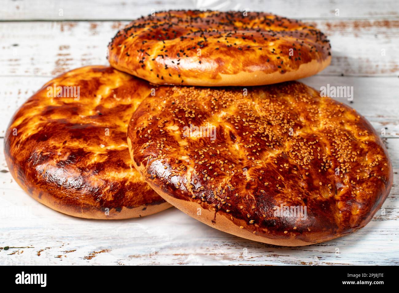 Pita de ramadan de sésame sur un plancher de bois. Spécialités du ramadan. Pain pita spécial pour le mois du Ramadan. Nom local pastane pidesi Banque D'Images