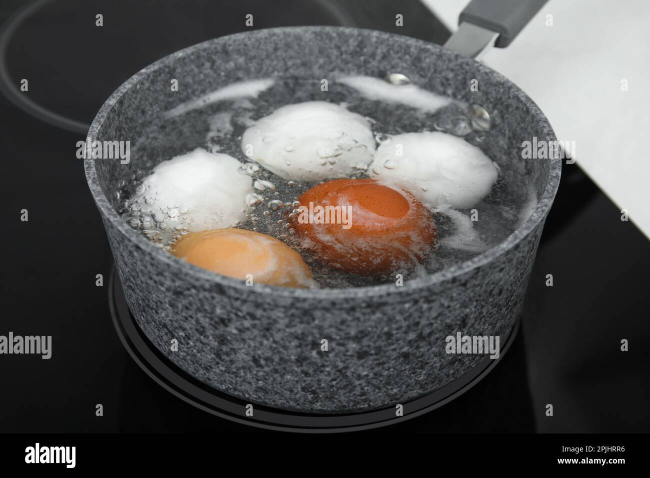 Faire bouillir les œufs de poulet dans une casserole sur une cuisinière électrique Photo Stock