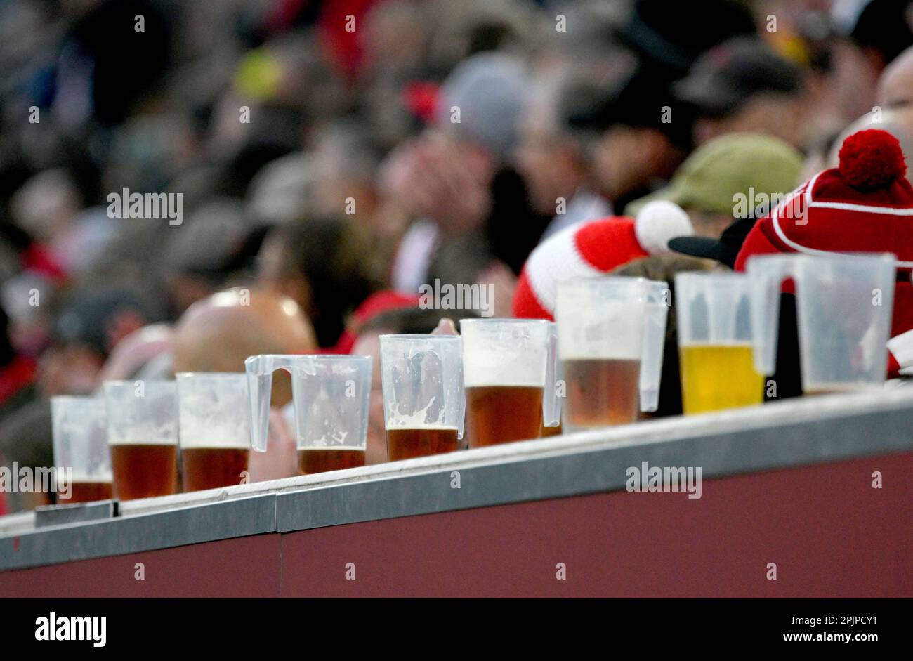 Merkur Spielarena Düsseldorf, 31,3.2023, Fussball, 2. Bundesliga Saison 2022/23 26.Spieltag Fortuna Düsseldorf (F95) contre Hamburger Sportverein (HSV) — Halb gefüllte Bierbecher aus Plastik stehen aufgereiht auf einer Bande vor den Zuschauern LES RÉGLEMENTATIONS DFL INTERDISENT TOUTE UTILISATION DE PHOTOGRAPHIES COMME SÉQUENCES D'IMAGES ET/OU QUASI-VIDÉO Banque D'Images