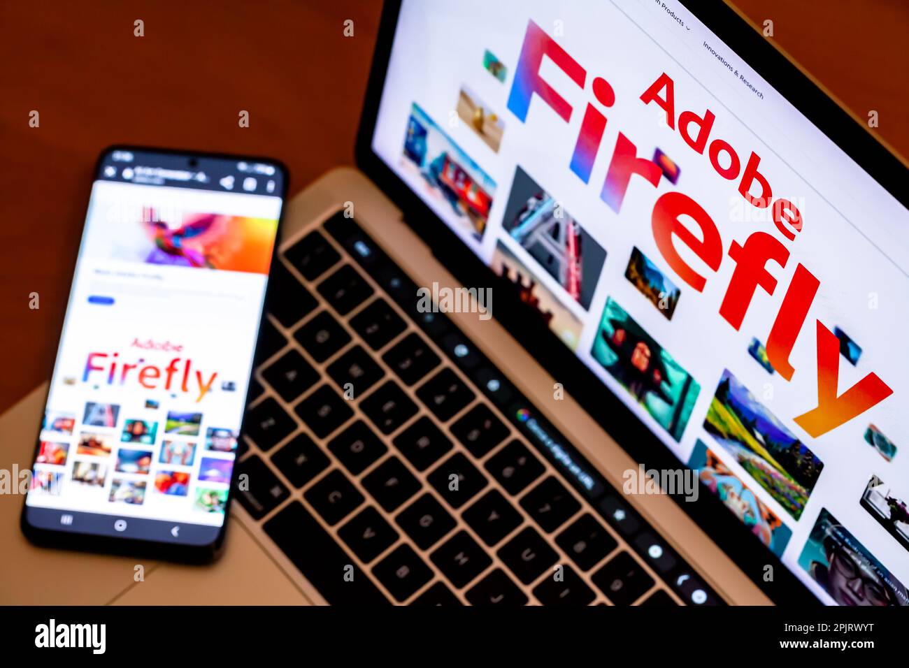 ITALIE - 3 avril 2023: Site Internet d'Adobe Firefly affiché sur smatphone et écran d'ordinateur portable. Adobe a annoncé la version bêta de son ai Art Generator à Banque D'Images