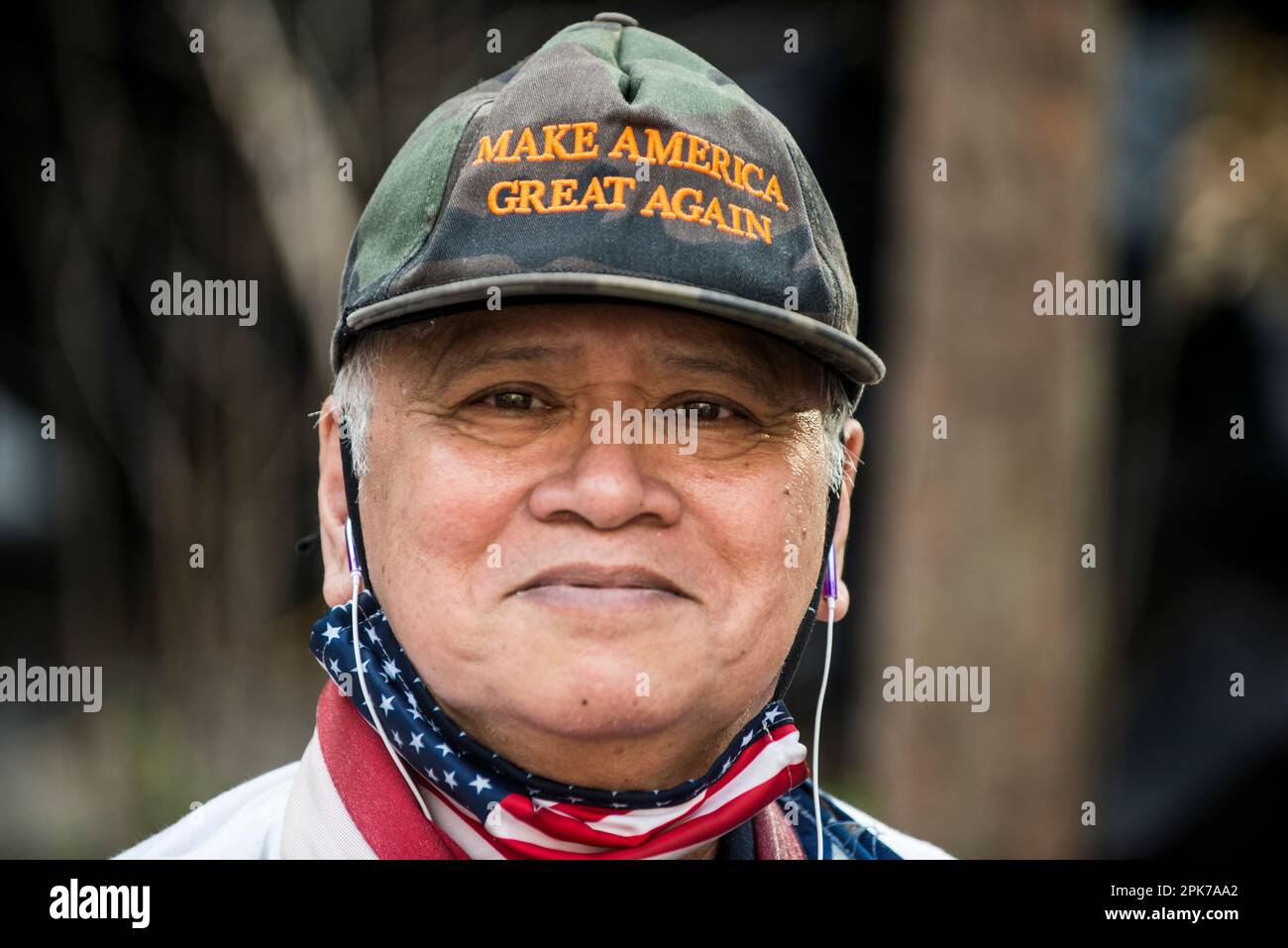 L'homme tient et porte le drapeau des États-Unis en soutien au président Trump lors de l'RAID au Tribunal criminel de Manhattan, à New York, aux États-Unis. 04 avril 2023. Banque D'Images