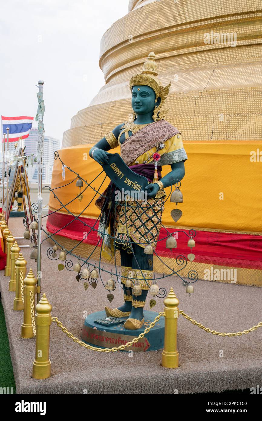 Sculpture thaïlandaise sur fond d'un grand stupa d'or du temple Wat Saket à Bangkok en Thaïlande. Banque D'Images