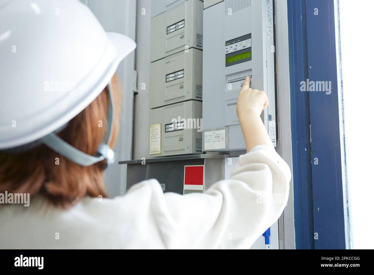 Femme vérifiant la sécurité avec un casque Banque D'Images