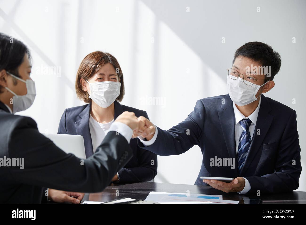 Employé de bureau avec un masque dans son bureau Banque D'Images