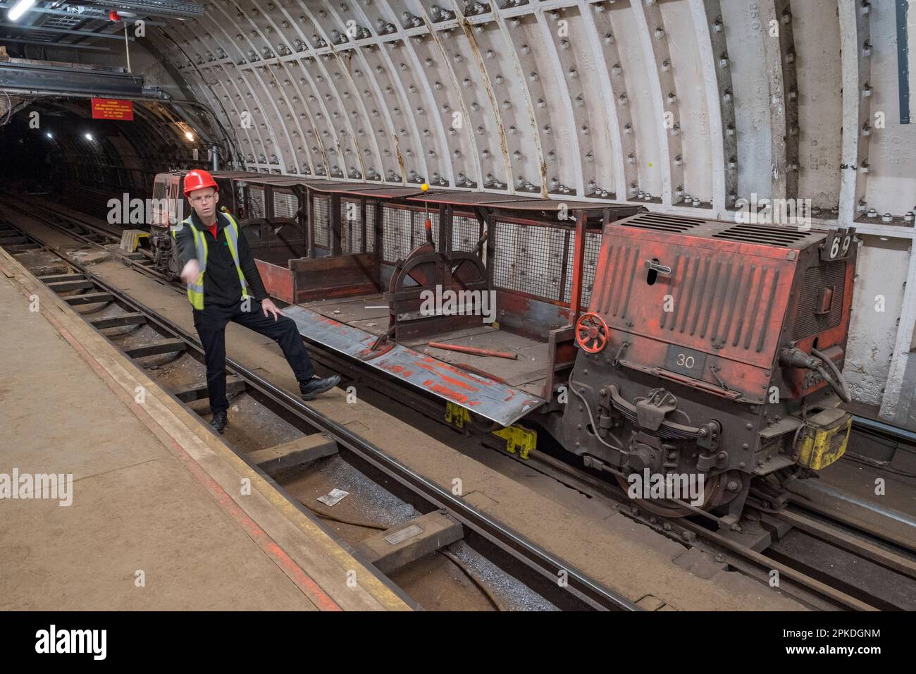 Guide montrant le groupe de l'un des petits trains Mail Rail originaux dans l'ancien système de chemin de fer de poste sous les rues du centre de Londres, Royaume-Uni. Banque D'Images