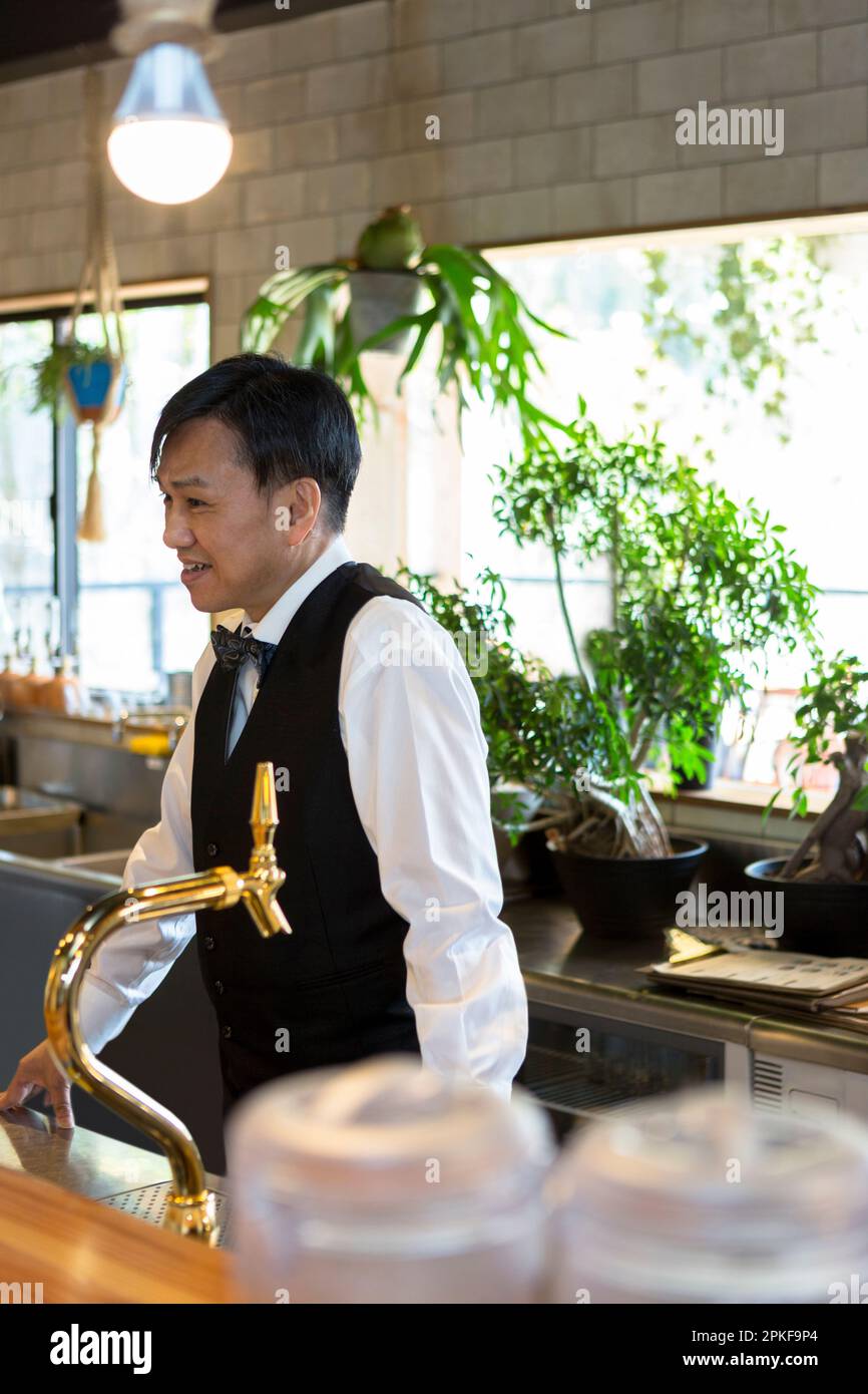 Serveuse masculine parlant avec un client Banque D'Images