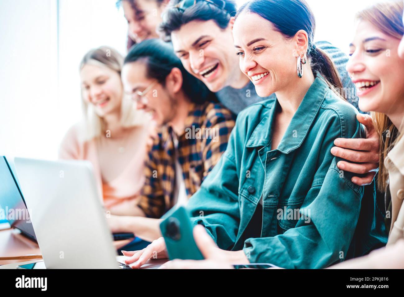 Jeunes étudiants de milléniums partageant du contenu sur ordinateur portable au studio de démarrage - mode de vie d'amis à la mode et concept de travail d'équipe sur le temps de travail de bureau Banque D'Images