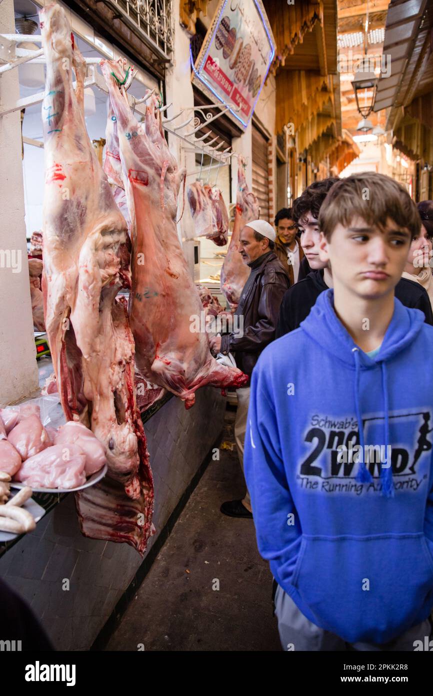 Un touriste américain se détourne de la viande crue à vendre dans un souk de Fès Medina Maroc Banque D'Images