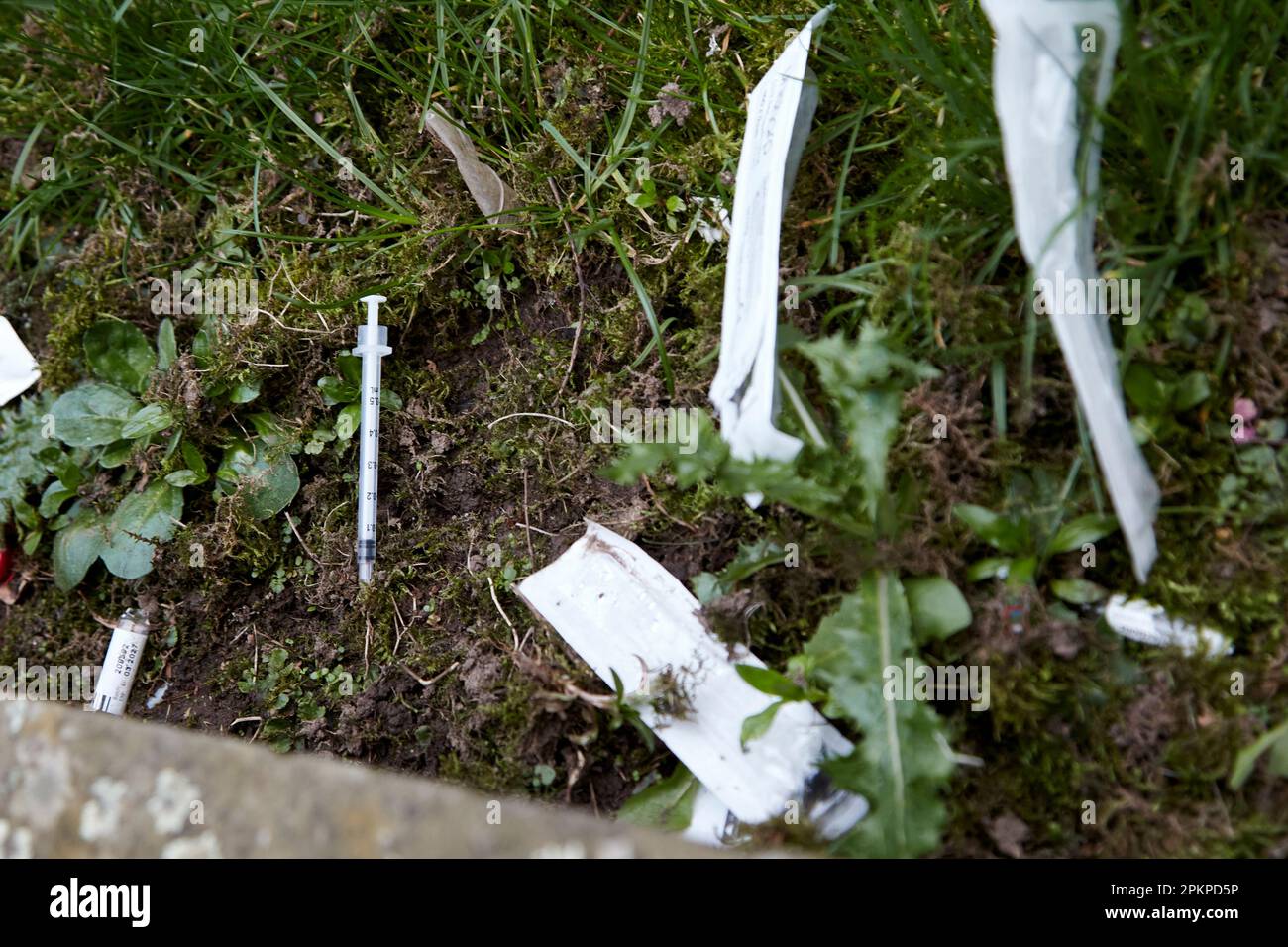 Aiguilles utilisées seringues et drogues paraphhernalia jetés dans le parc public du quartier de la cathédrale de Writers Square Belfast City Centre, Irlande du Nord, Banque D'Images