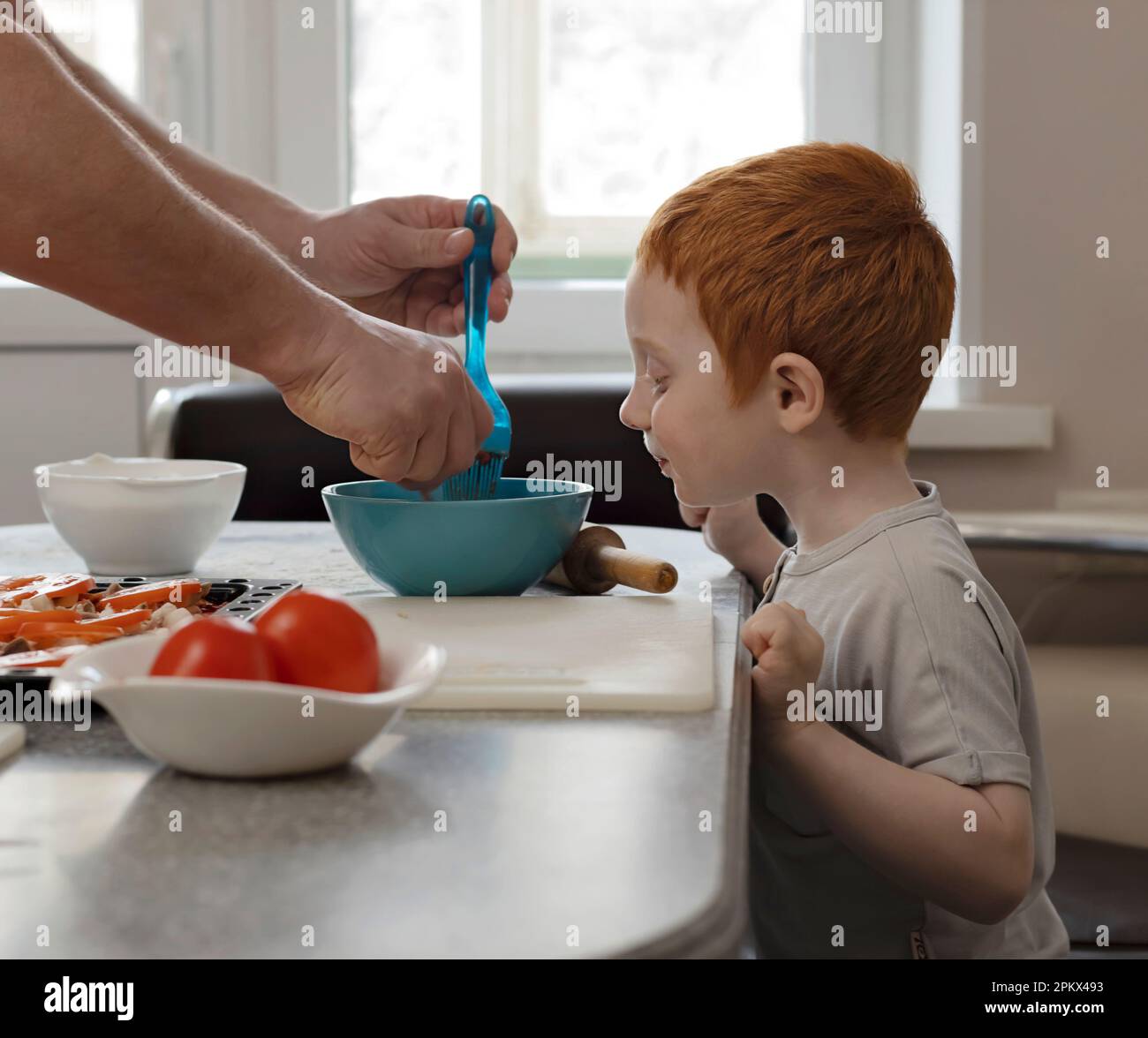 L'enfant examine la nourriture sur l'assiette. Banque D'Images