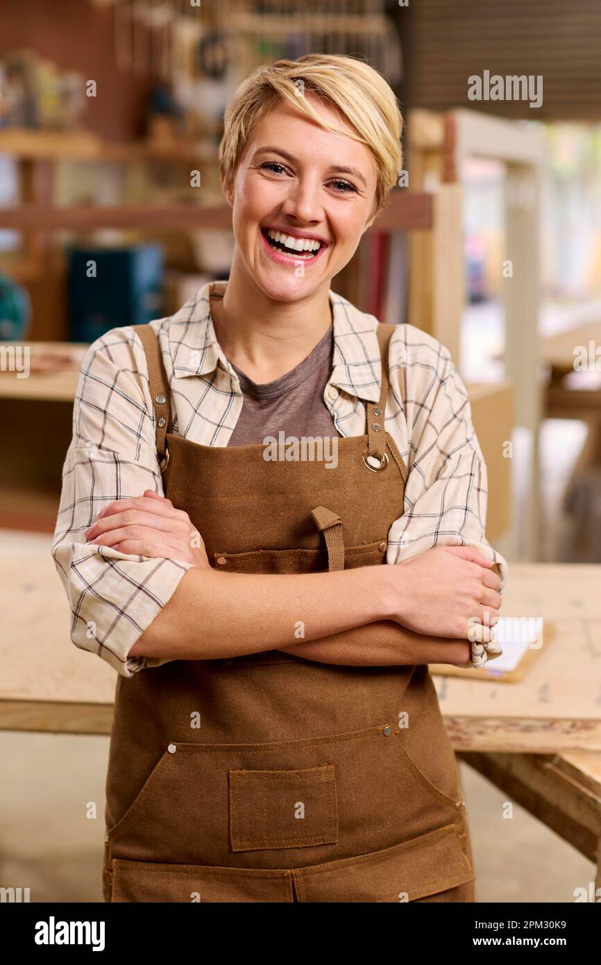 Portrait d'apprenti féminin travaillant comme menuisier dans l'atelier de meubles Banque D'Images