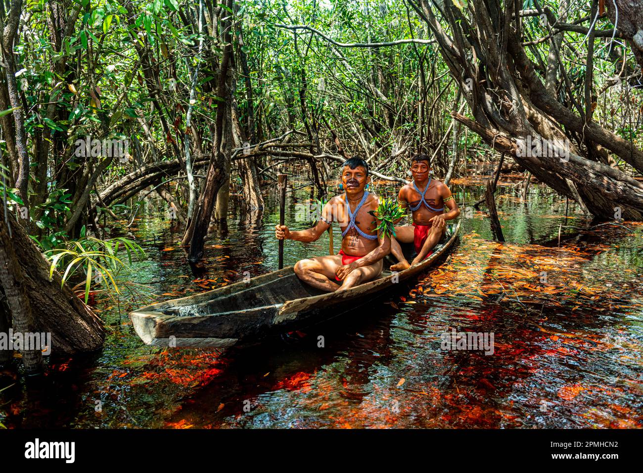Des hommes de la tribu Yanomami en canoë, dans le sud du Venezuela, en Amérique du Sud Banque D'Images
