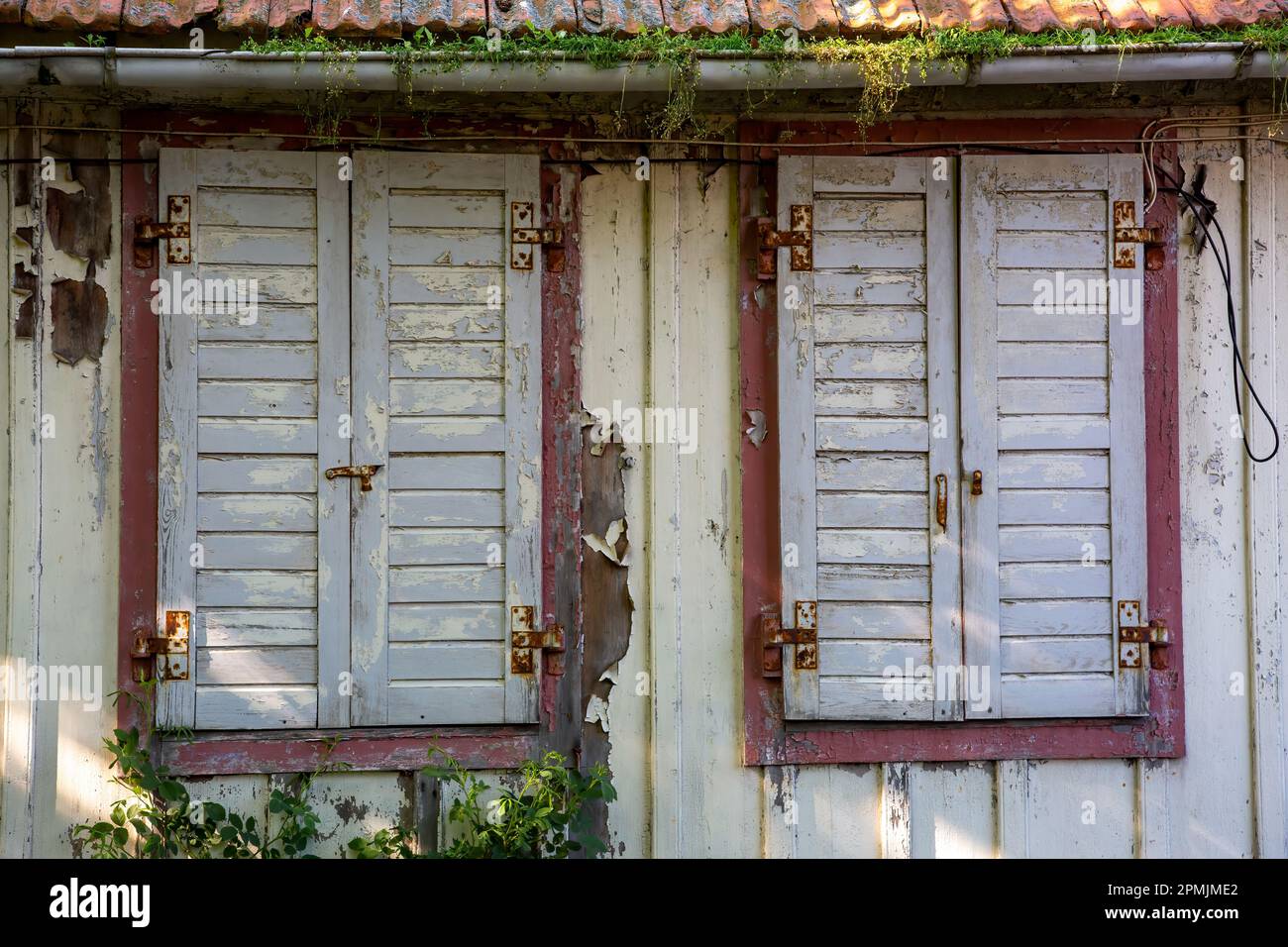 Vieux temps fermé volets en bois dans une maison abandonnée Banque D'Images