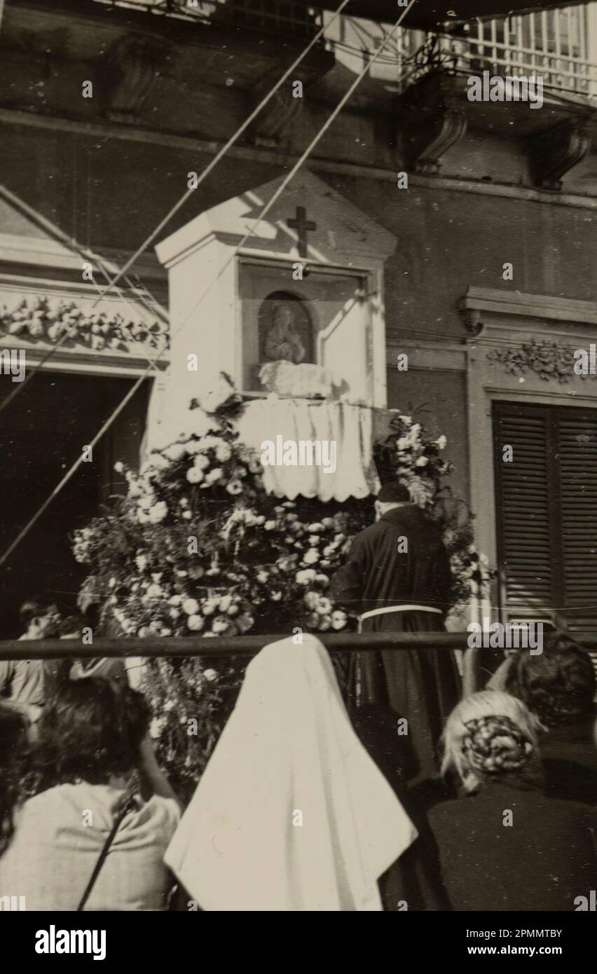 Rome, Italie mai 1951: Photo d'époque d'un prêtre priant devant un autel pendant le 1950s Banque D'Images