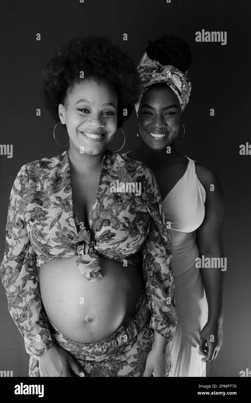 Portrait noir et blanc de deux femmes, amis, l'une d'entre elles est enceinte. Concept d'amitié. Banque D'Images